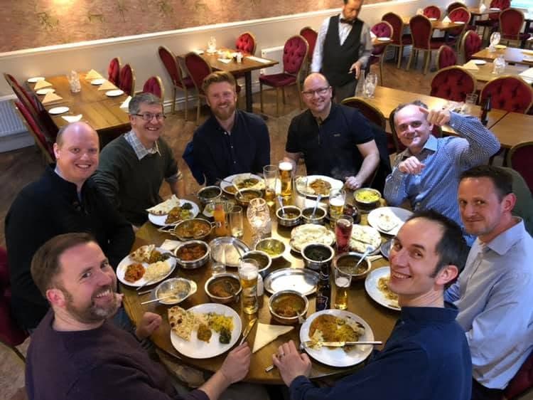 Dads sharing a meal around a restaurant table